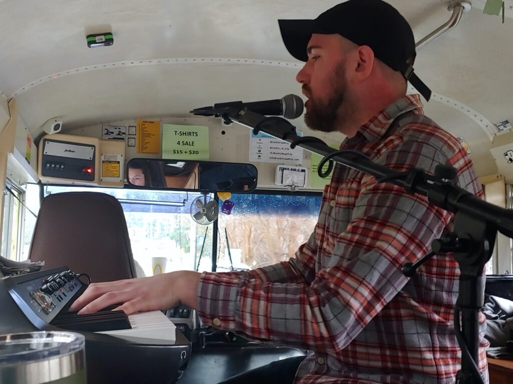Live Musician Playing for a party on the Rockin Road Trip bus.