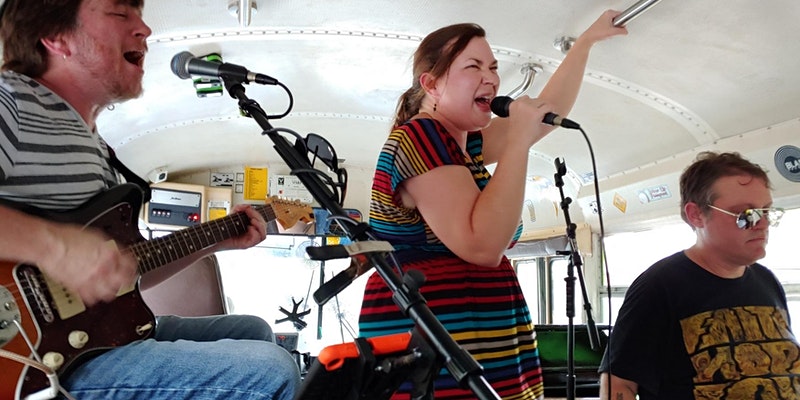 Live band performing during transportation to a venue in Atlanta, GA while ridding on the Rockin Road Trip party bus.