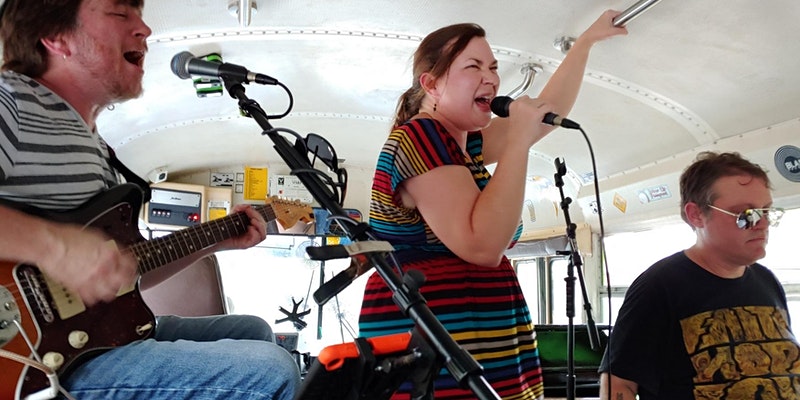 Live band performing on the Rockin Road Trip party bus on the way to a destination in Atlanta, GA.