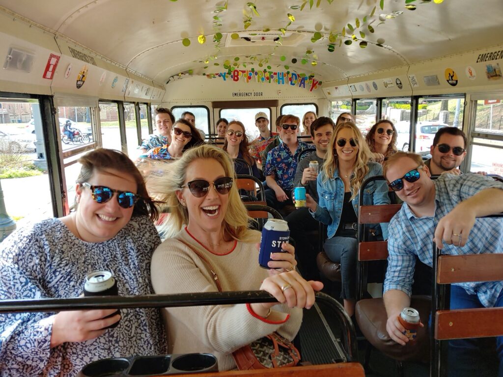 Party goers enjoying drinks and music with a live band during their brewery tour in Atlanta, GA on the Rockin Road Trip party bus.